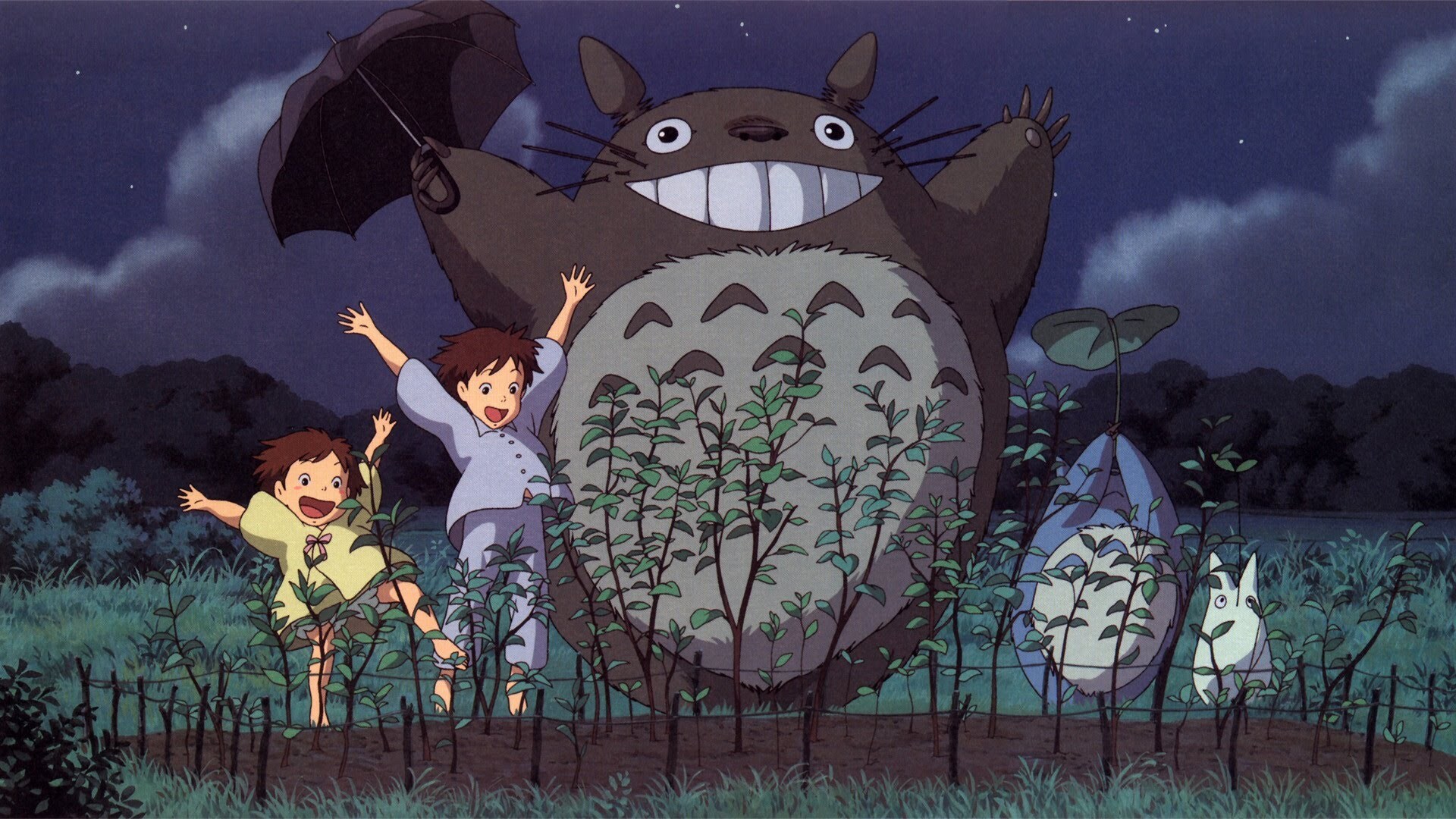 Totoro, two children, and two other forest creatures celebrating the plants they grew.