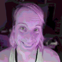 A low resolution purple-tinted photo of Kira, a girl smiling at the camera.